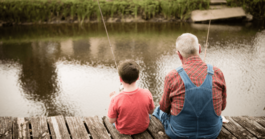 Grandfather fishing with his grandson while waiting for cancer results.