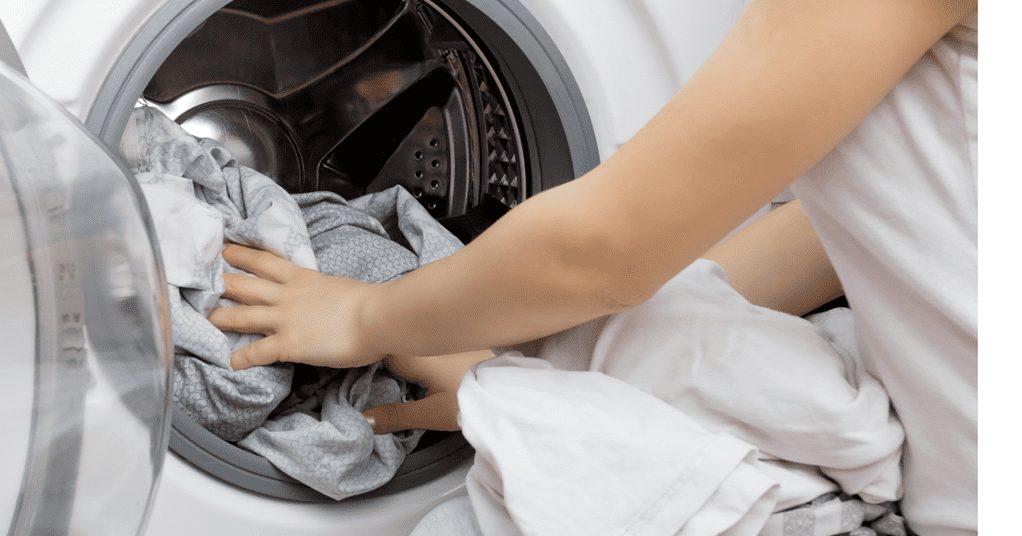 Woman pulling laundry out of the dryer.