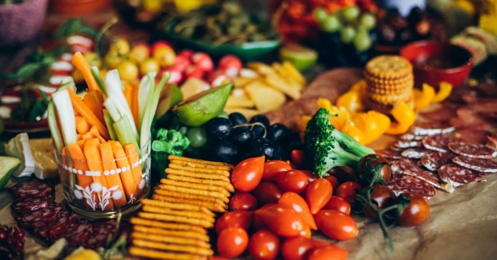 Charcuterie of cheese and crackers, fruit and vegtables sticks