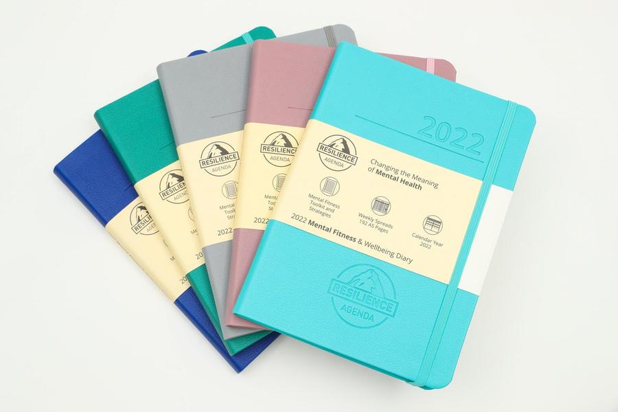 Resilience Mental Fitness and Wellbeing Diary fanned out in 5 colors.
