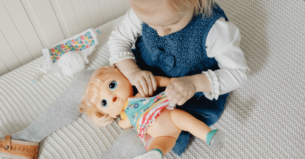 Young girl playing with her baby doll.