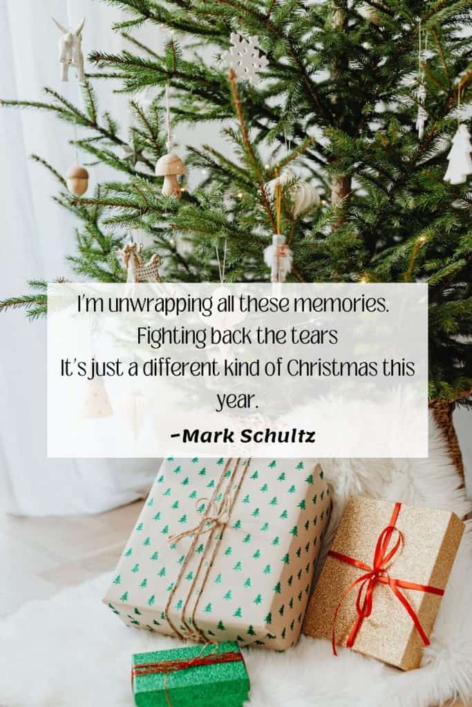 Christmas tree with presents underneath text overlay says I’m unwrapping all these memories.   Fighting back the tears It’s just a different kind of Christmas this year. ~Mark Schultz