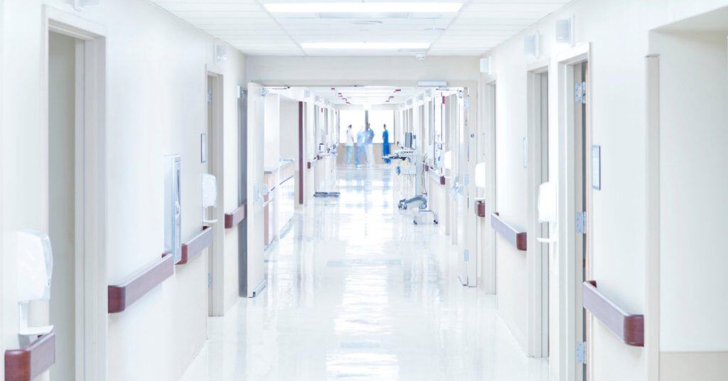 Sanitized and white image of a hospital hallway.