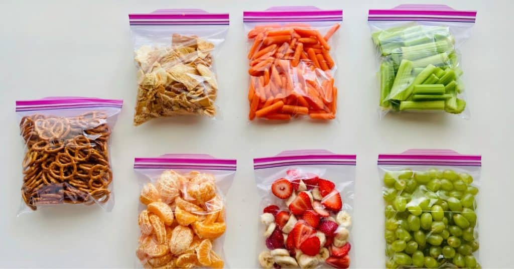 zip loc bags of healthy snacks. Pretzels, carrot sticks, berrues and oranges