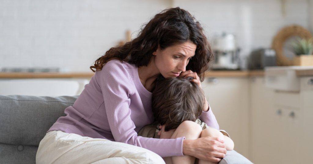 A woman supporting her child through a cancer discussion,